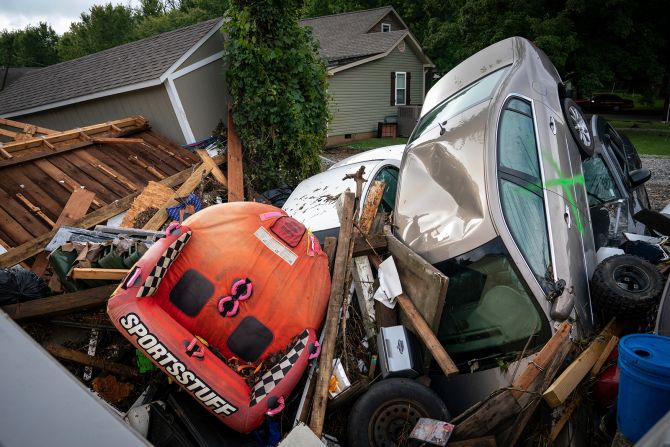 Cars and debris are stacked high along Simpson Avenue in Waverly.