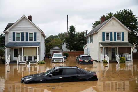 Cars are submerged on a residential street following a flash flood in Helmetta, New Jersey.