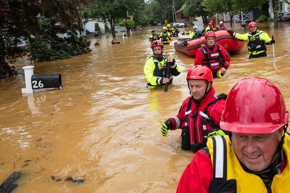 Members of the New Market Volunteer Fire Company search through flooded streets in Helmetta, New Jersey, on August 22.