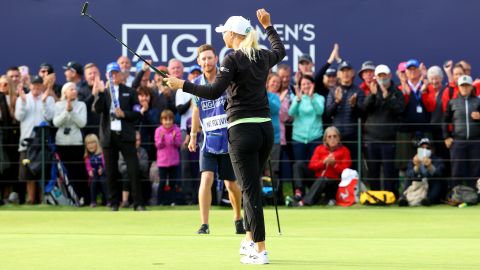 Nordqvist celebrates on the 18th green with her caddie.