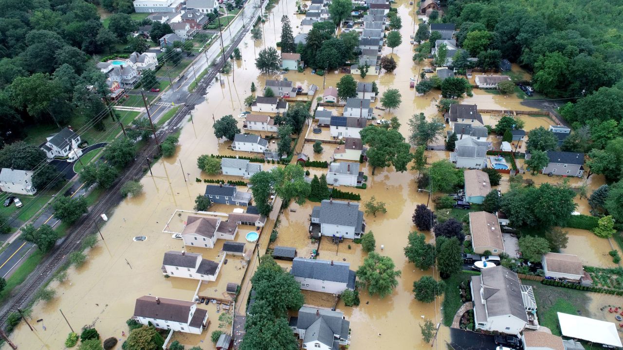 Aug 22, 2021; Helmetta, New Jersey, USA; Overnight heavy rains left John Street (right) and Railroad Avenue in Helmetta flooded. Mandatory Credit: Thomas P. Costello & Mike Davis-USA TODAY Sports