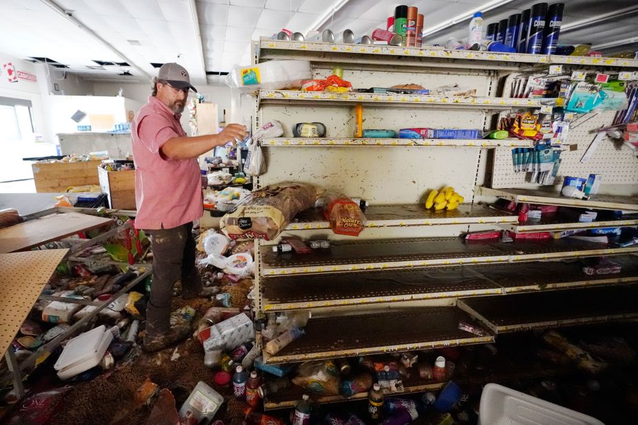 John Curtis, co-owner of the Waverly Cash Saver grocery store, walks through his damaged store on Sunday, August 22.