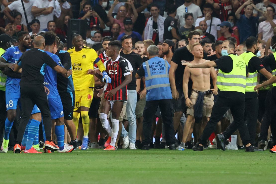 Fans try to invade the pitch during the match between Nice and Marseille.
