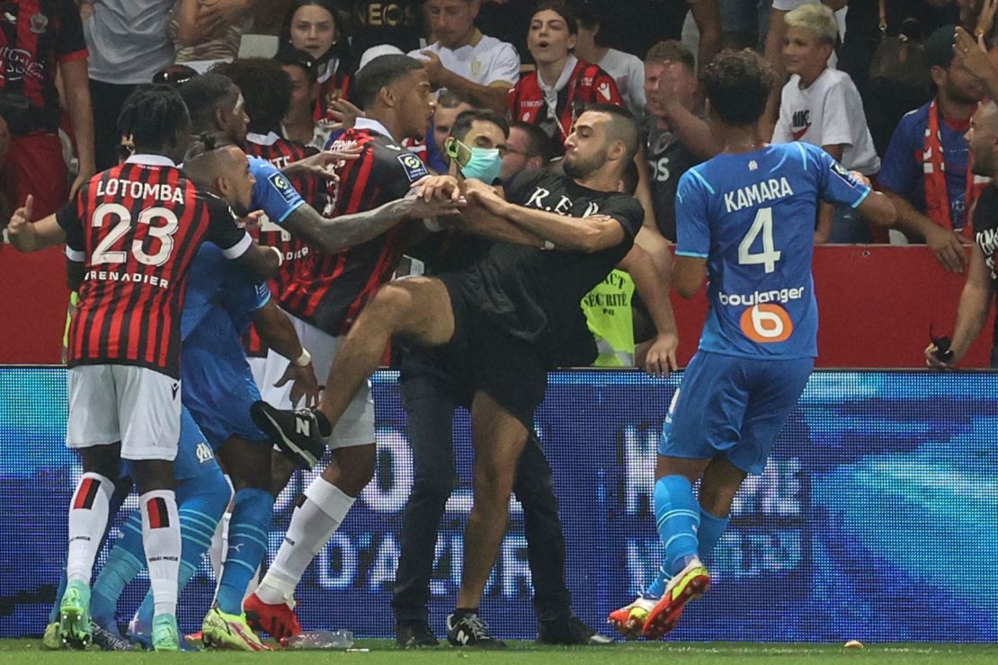 In an August 22 match, Payet reacts as players from Nice and Marseille stop a fan invading the pitch.