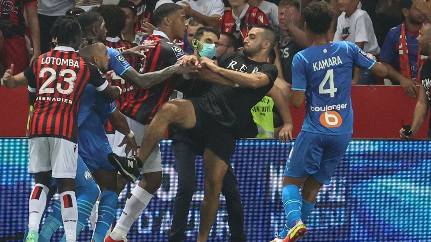 Dimitri Payet (second left) reacts as players from Nice and Marseille stop a fan invading the pitch.