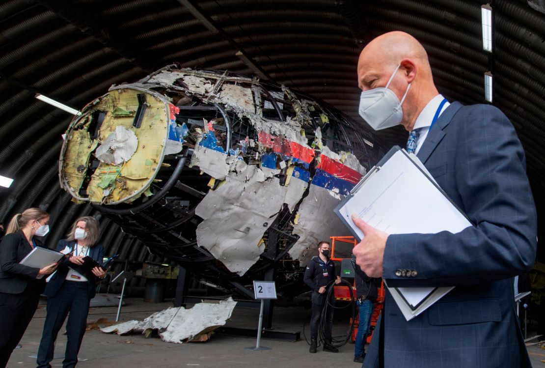 The reconstructed wreckage of Flight MH17 is seen behind presiding judge Hendrik Steenhuis, one of a team of judges and lawyers who assessed the evidence around the tragedy.