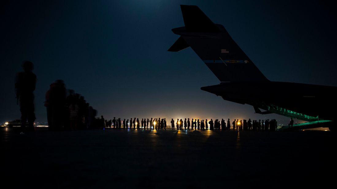 In this photo released by the US Air Force, an air crew prepares to load evacuees onto a C-17 transport plane at the airport in Kabul on August 21.