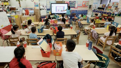 Melissa Moy, a teacher at Yung Wing School P.S. 124, goes over a lesson on a monitor with in-person Summer program students on July 22 in New York City.