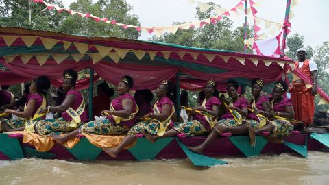 Women dance in a regatta to mark the coronation of Prince Tsola Emiko as the 21st king or the Olu of Warri kingdom and the Ogiame Atuwatse 111 at Ode Itsekiri.