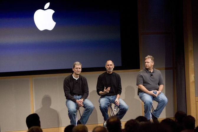 From left, then-Apple COO Tim Cook, Apple CEO Steve Jobs and Phil Schiller, executive vice president for product marketing, answer questions after Jobs introduced new versions of the iMac and the iLife software applications at Apple's headquarters in Cupertino, California, in 2007. 