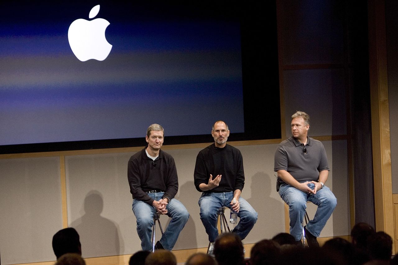 From left, then-Apple COO Tim Cook, Apple CEO Steve Jobs and Phil Schiller, executive vice president for product marketing, answer questions after Jobs introduced new versions of the iMac and the iLife software applications at Apple's headquarters in Cupertino, California, on August 7, 2007. 