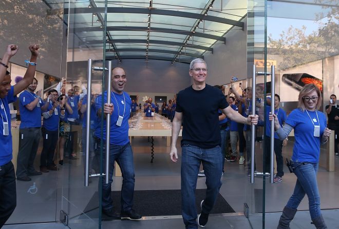 Cook opens the door to an Apple Store in Palo Alto to begin sales of the new iPhone 6 in September 2014. Hundreds of people lined up to purchase the new iPhone 6 and iPhone 6 Plus that went on sale that day.