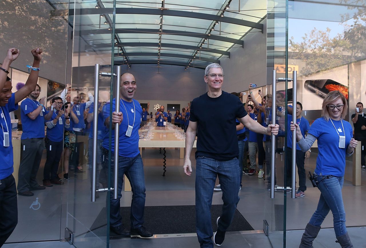 Cook opens the door to an Apple Store to begin sales of the new iPhone 6 on September 19, 2014 in Palo Alto, California. Hundreds of people lined up to purchase the new iPhone 6 and iPhone 6 Plus that went on sale that day.