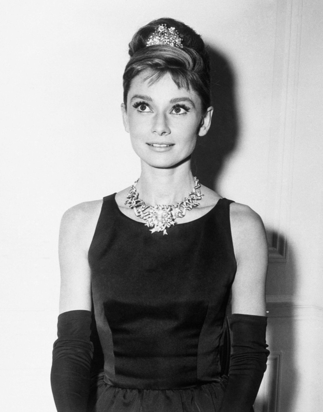 Audrey Hepburn, about to begin filming for Breakfast At Tiffany's, wears one of the store's most expensive diamond necklaces.