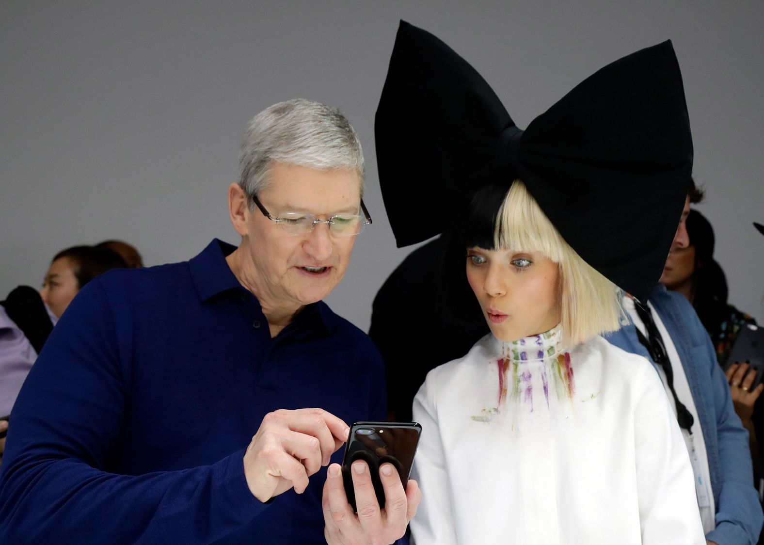 Cook shows an iPhone 7 to performer Maddie Ziegler during an event to announce new products in San Francisco in September 2016.