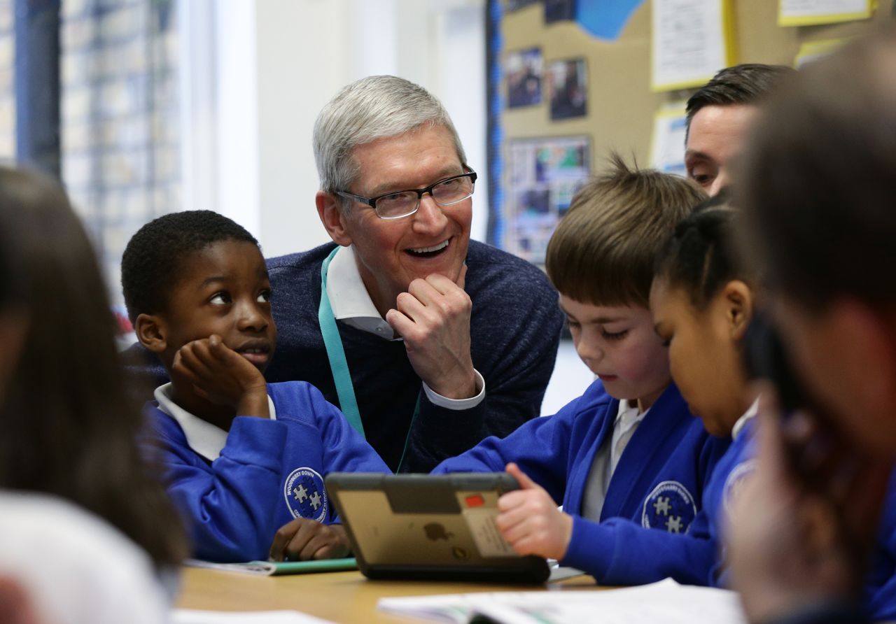 Cook with students at Woodberry Down Community Primary School in Harringay in north London in February 2017. Cook was visiting to see how the school had incorporated Apple's iPad and related software in its curriculum.