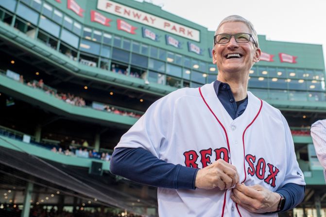 Tim Cook puts on a Boston Red Sox jersey before a baseball game between the Red Sox and the Detroit Tigers in June 2017.