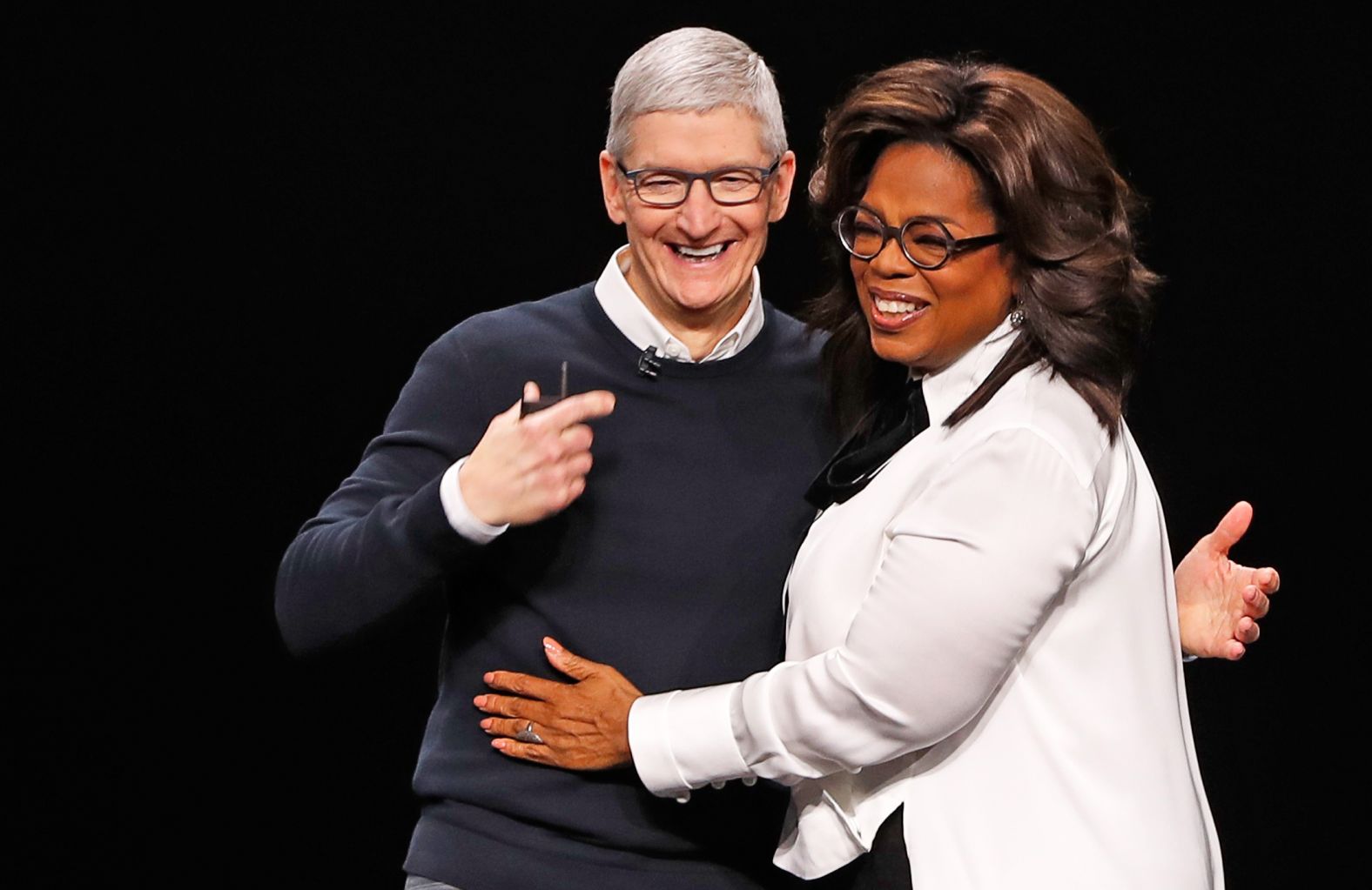 Cook and Oprah Winfrey hug during an Apple special event in Cupertino in March 2019.