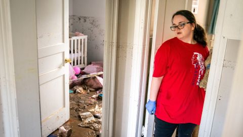 Vanessa Yates checks the damage inside her home in Waverly following the flood.