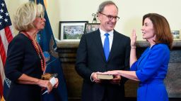Kathy Hochul, right, is administered the oath of office as New York State governor by Court of Appeals Chief Judge Janet DiFiore on a Bible held by her husband Bill Hochul in the Red Room at the state Capitol early morning of Aug. 24, 2021 in Albany, New York. Hochul was sworn in just past midnight as the state's 57th governor, the first women to ascend to the state's highest office. 