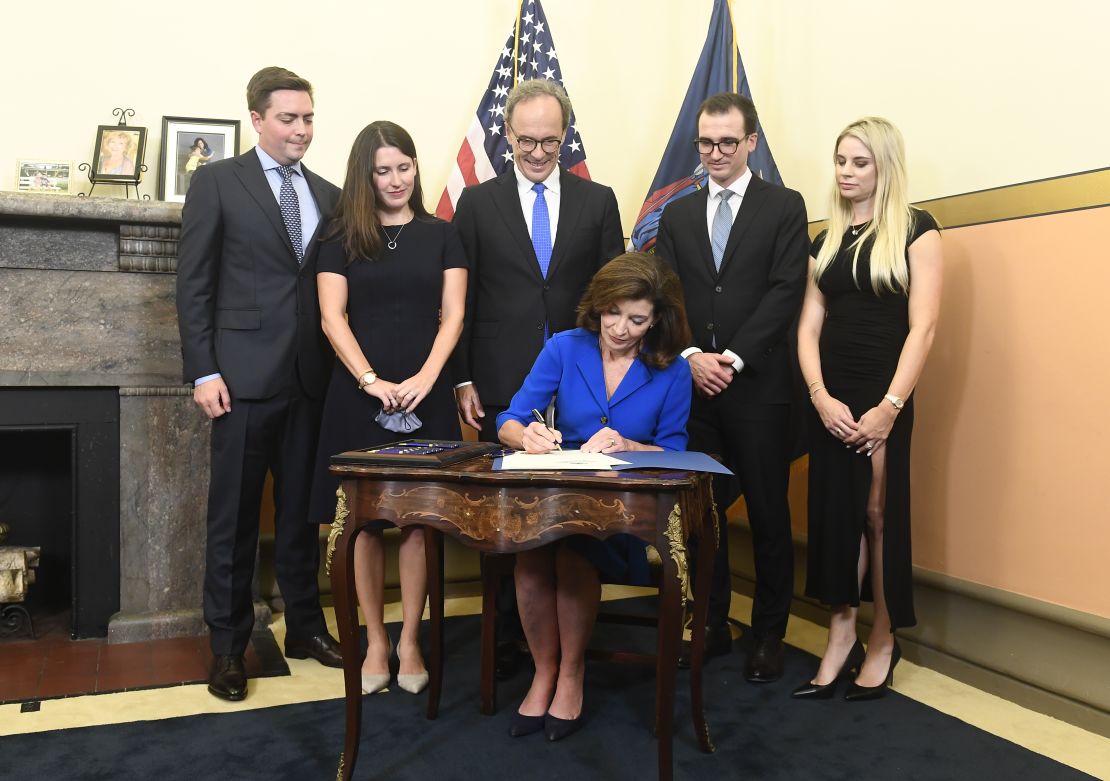 Kathy Hochul signs documents at her swearing-in the state Capitol in Albany, New York. Hochul was sworn in just past midnight as the state's 57th governor. 