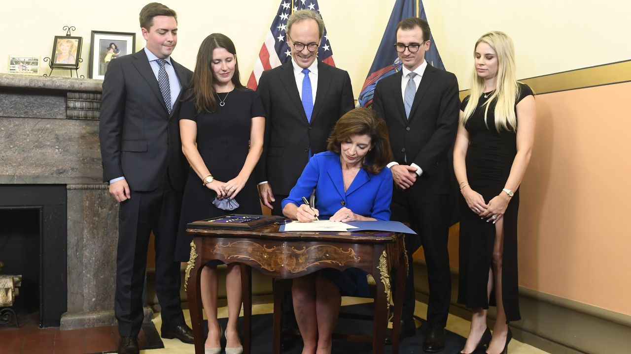 Kathy Hochul signs documents at her swearing-in the state Capitol in Albany, New York. Hochul was sworn in just past midnight as the state's 57th governor.
