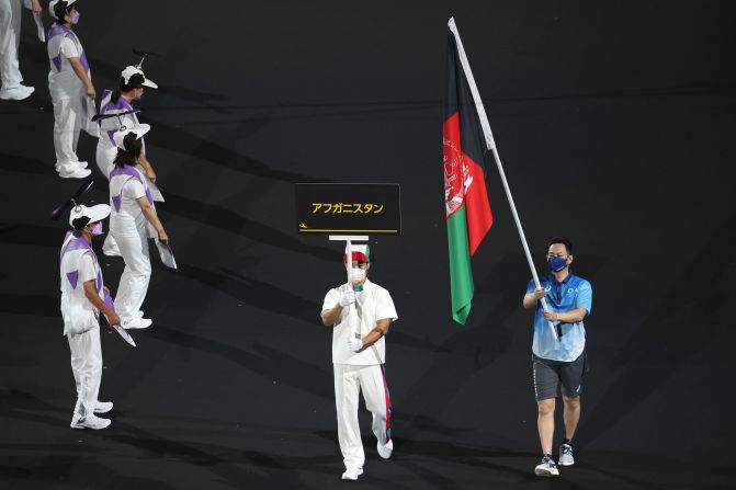 <a href="index.php?page=&url=https%3A%2F%2Fwww.cnn.com%2F2021%2F08%2F24%2Fsport%2Fparalympics-afghanistan-tokyo-2020-preview-spt-intl%2Findex.html" target="_blank">The flag of Afghanistan is presented</a> by volunteers at the ceremony. Afghanistan was the focus of the world's attention after <a href="index.php?page=&url=http%3A%2F%2Fwww.cnn.com%2F2021%2F08%2F16%2Fmiddleeast%2Fgallery%2Ftaliban-afghanistan%2Findex.html" target="_blank">the Taliban seized the capital,</a> and Afghan athletes pulled out of the Paralympics due to flights being canceled from the country. "We would like to have them here. Unfortunately it is not possible, but they will be here in spirit," said Andrew Parsons, president of the International Paralympic Committee, on the eve of the ceremony.