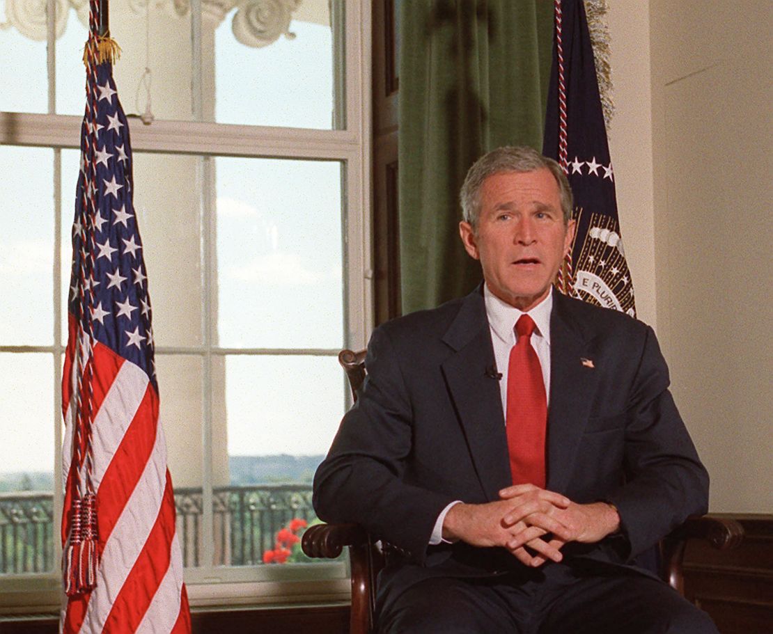 Then-President George W. Bush poses for photographers in the White House in Washington, DC, October 7 2001, after announcing that the US launched attacks against Afghanistan as a new front in its war on terrorism.