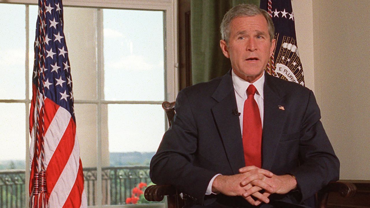 Then-President George W. Bush poses for photographers in the White House in Washington, DC, October 7 2001, after announcing that the US launched attacks against Afghanistan as a new front in its war on terrorism.
