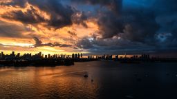 The Miami skyline is seen as the sun sets in the background in South Bay, Miami Beach, on February 24, 2021.
