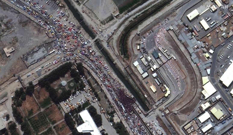 This satellite image shows crowds gathered outside a gate to the international airport in Kabul on August 23. Western countries were in <a href="index.php?page=&url=https%3A%2F%2Fwww.cnn.com%2F2021%2F08%2F23%2Fasia%2Fkabul-airport-afghanistan-intl-hnk%2Findex.html" target="_blank">a frantic race</a> to complete what US President Joe Biden called "one of the largest, most difficult airlifts in history."