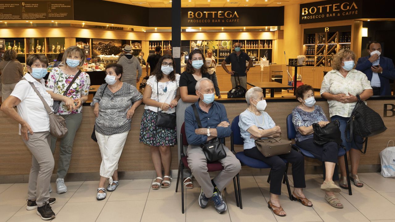 Members of the Naldi family wait to meet Adler at Bologna's airport.