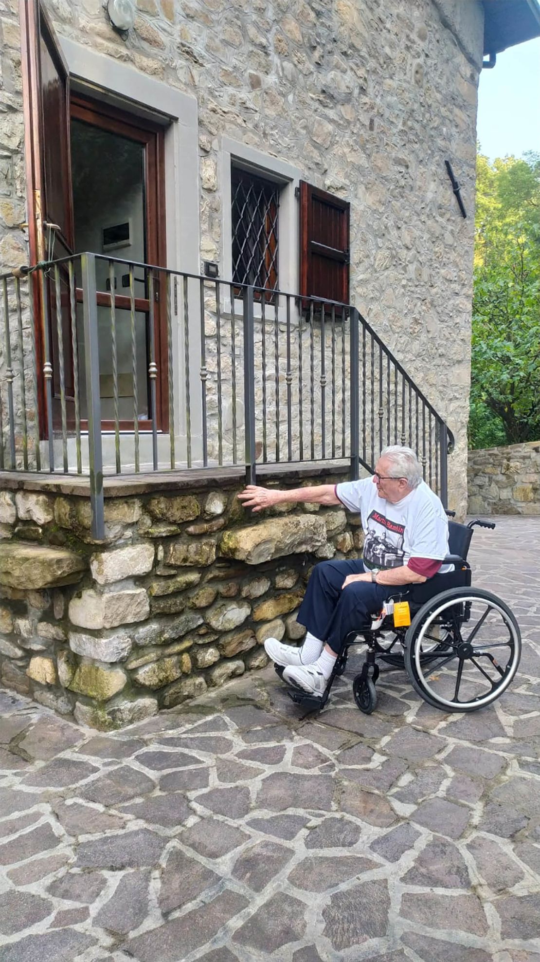  Adler pictured outside the house in the village of Monterenzio where he found the siblings.