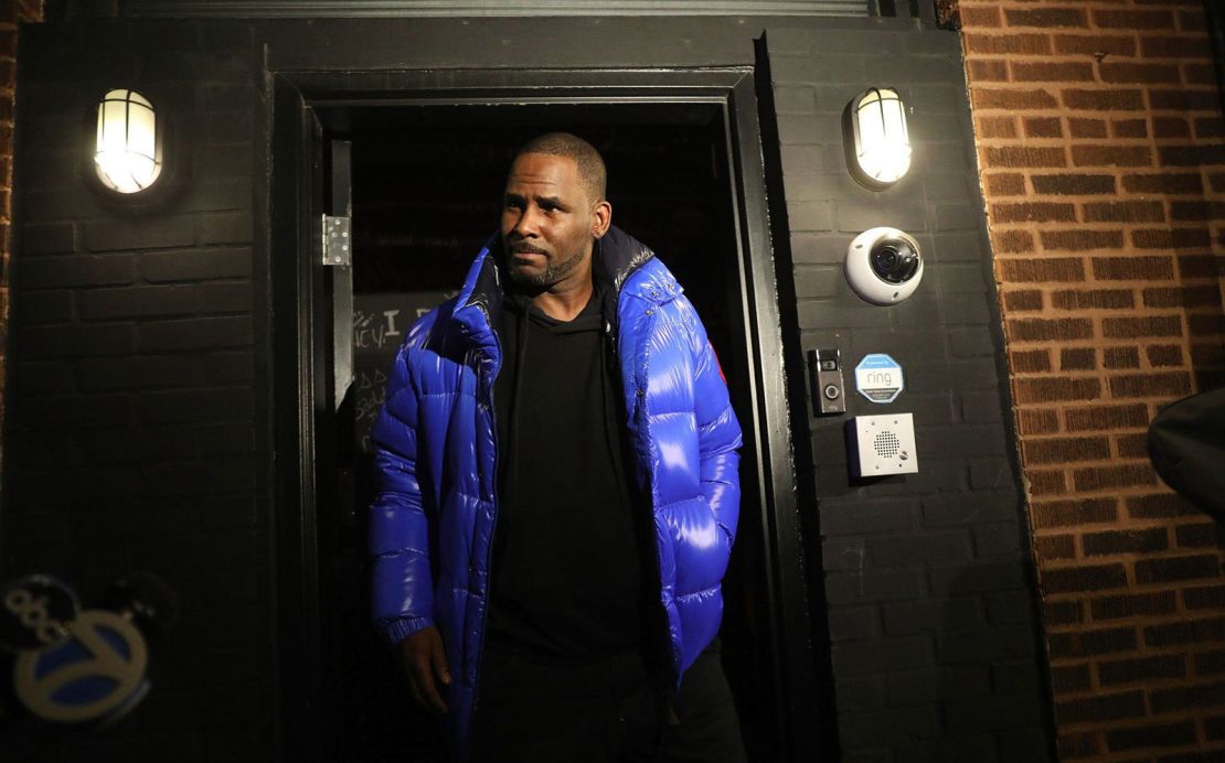 R. Kelly emerges from his studio before turning himself in to Chicago police on February 22, 2019.