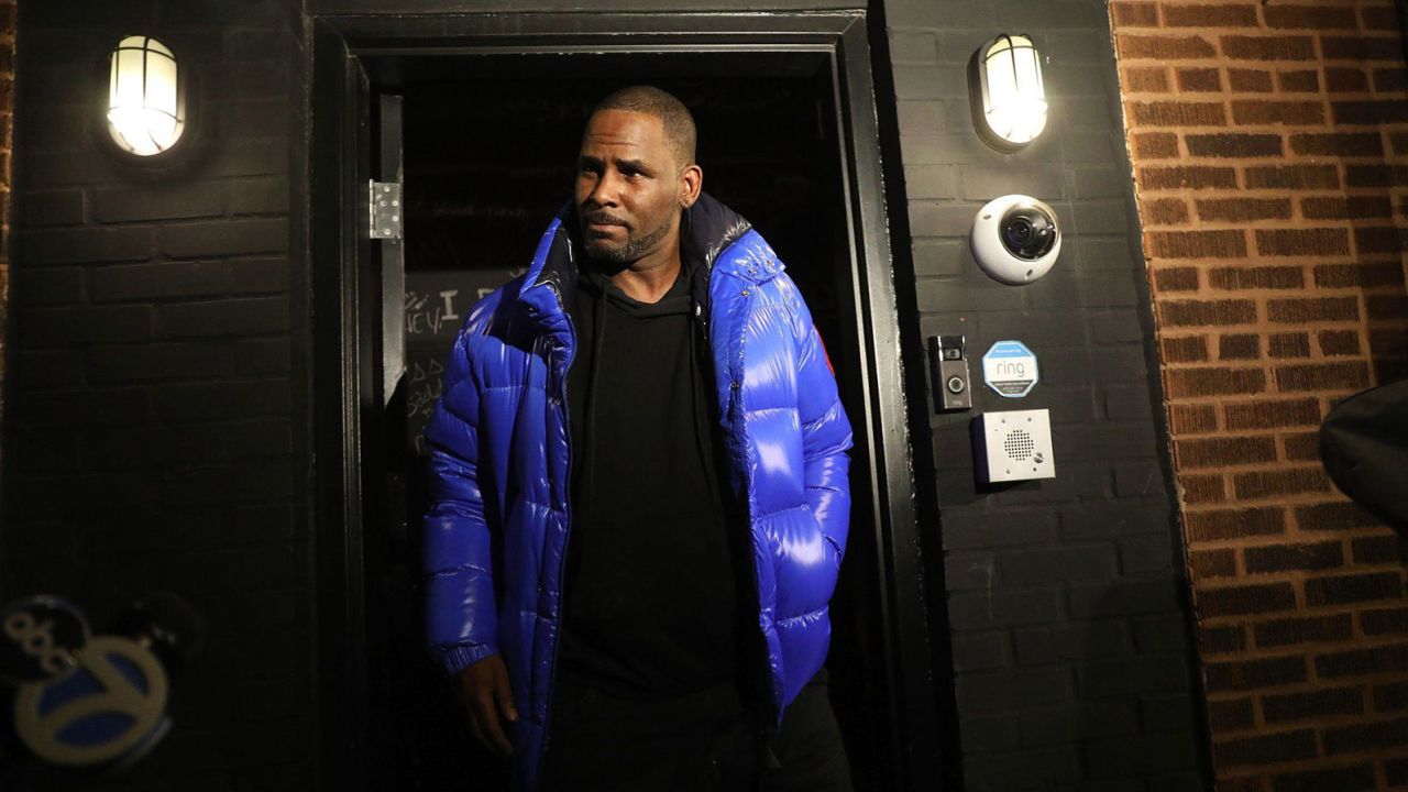 R. Kelly emerges from his studio before turning himself in to Chicago police on February 22, 2019.