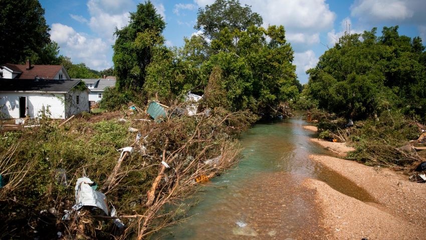 WAVERLY, TN - AUGUST 23:  Debris hang in the trees around Trace Creek which rose to deadly levels over the weekend on August 23, 2021 in Waverly, Tennessee. Heavy rains on Sunday caused flash flooding in the area, leaving at least 22 people dead and more than two dozen missing. (Photo by Brett Carlsen/Getty Images)