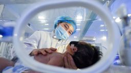 A medical worker takes care of a newborn baby lying inside an incubator at Jingzhou Maternity & Child Healthcare Hospital on the eve of Chinese New Year, the Year of the Ox, on February 11 in Jingzhou, Hubei Province of China.