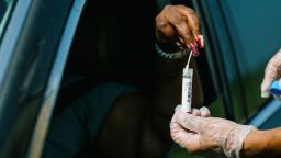 A member of the National Guard collects a Covid-19 swab test from a driver at the University of New Orleans Lakefront Arena drive-thru facility in New Orleans, Louisiana, U.S., on Tuesday, Aug. 24, 2021. The Louisiana Department of Health reported an increase in confirmed Covid-19 cases by 8,296 on Monday. Photographer: Bryan Tarnowski/Bloomberg via Getty Images