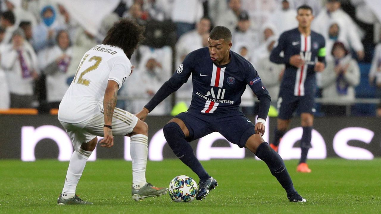 Mbappe dribbles past Real Madrid's Marcelo during the  Champions League.
