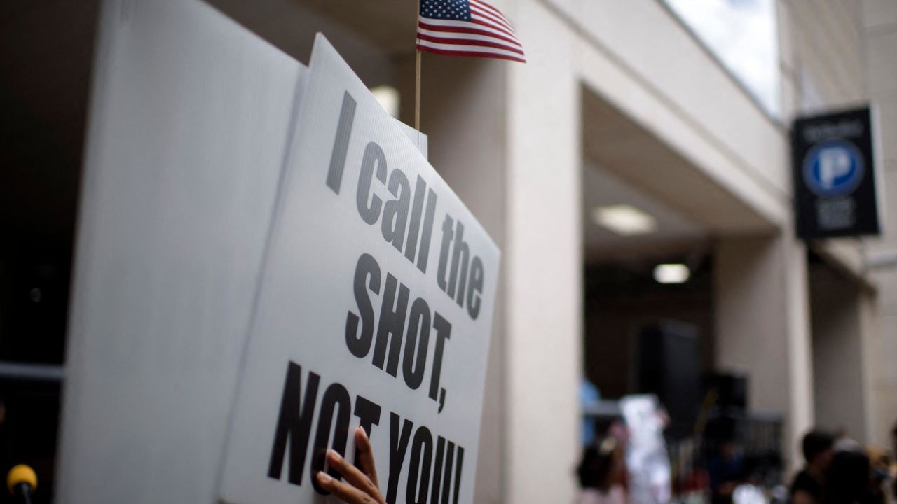 Anti-vaccine rally protesters hold signs outside of Houston Methodist Hospital in Houston, Texas, on June 26, 2021.