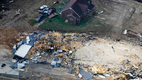 Damaged homes and cars are seen Wednesday in Waverly, Tennessee.