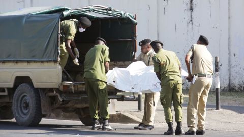 Tanzanian security forces remove the slain body of an attacker who was wielding an assault rifle, outside the French embassy in the Salenda area of Dar es Salaam, Tanzania August 25, 2021.