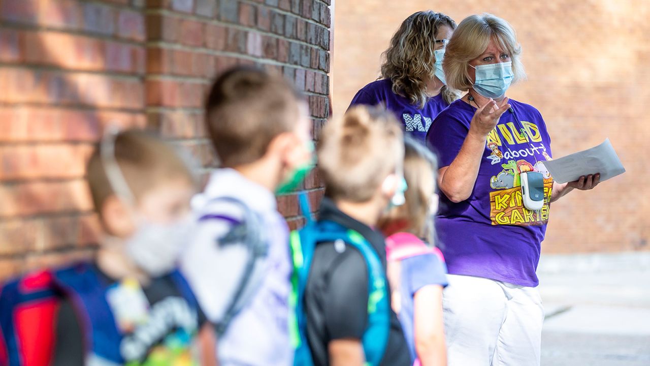 Kindergarten teacher Shelly Kelly talks with her students as they line up on the first day of school for District 186 at Owen Marsh Elementary School in Springfield, Illinois, on Monday, August 23.