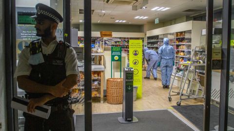 Forensic investigators pictured inside one of the affected supermarkets.