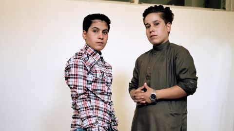 Ali, 14, wears jeans and a shirt while her sister Setar, 16, wears a traditional outfit for men, in Kabul,  in a practice known as "bacha posh," in a picture taken in June 2017. 