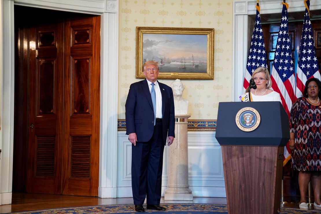 Cleta Mitchell speaks during an event marking the 100th Anniversary of the 19th Amendment ratification with President Donald Trump, left, in the Blue Room of the White House on August 18, 2020.