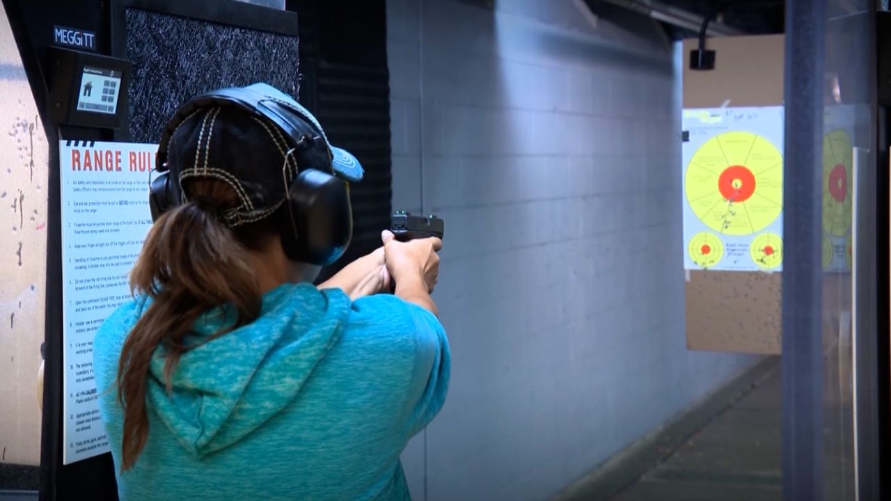 A woman fires a gun at a shooting range. CDC Director Dr. Rochelle Walensky wants to work with gun owners to investigate ways to prevent gun injuries and deaths.