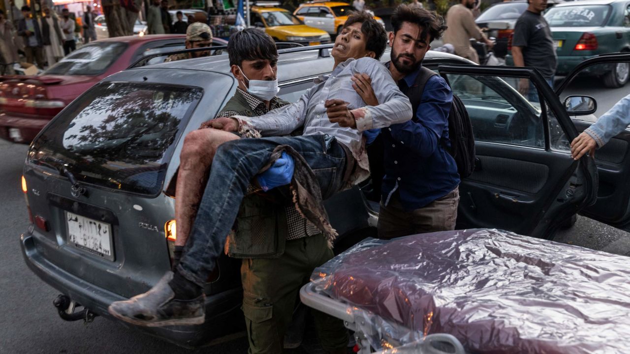 A person wounded in the explosion outside the airport arrives at a hospital in Kabul.