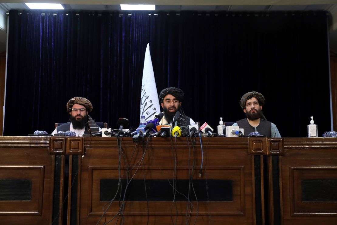 Taliban spokesman Zabihullah Mujahid, center, speaks at his first news conference at the Government Media Information Center, in Kabul, Afghanistan, Tuesday, Aug. 17, 2021. 