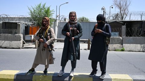 Taliban fighters stand guard along a street in Kabul on August 16, 2021. 